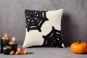 white canvas throw pillow cover with black spiderweb yarn pattern